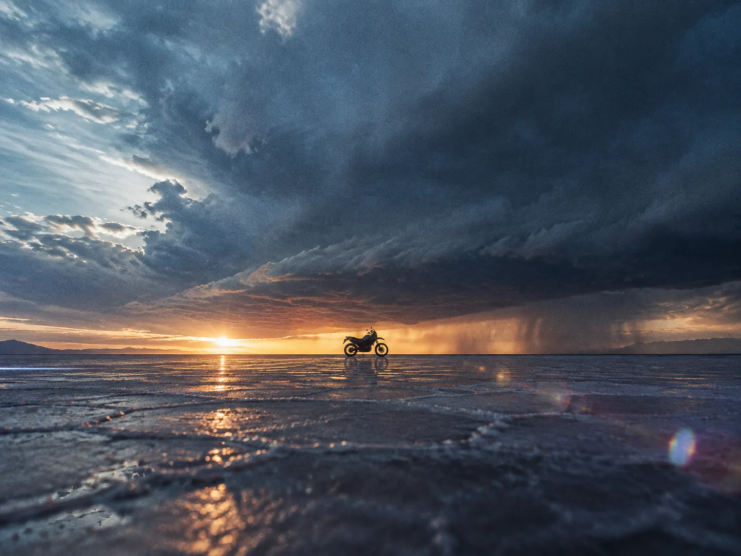 A wide salt flat title sequence frame at dusk